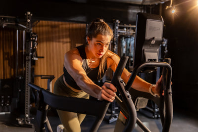 Athlete watching the console while using the REP Fitness Strive Curved Treadmill