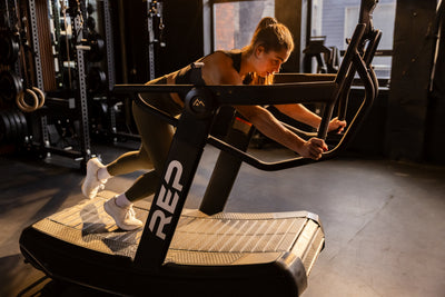Athlete pushing in sled mode on the REP Fitness Strive Curved Treadmill