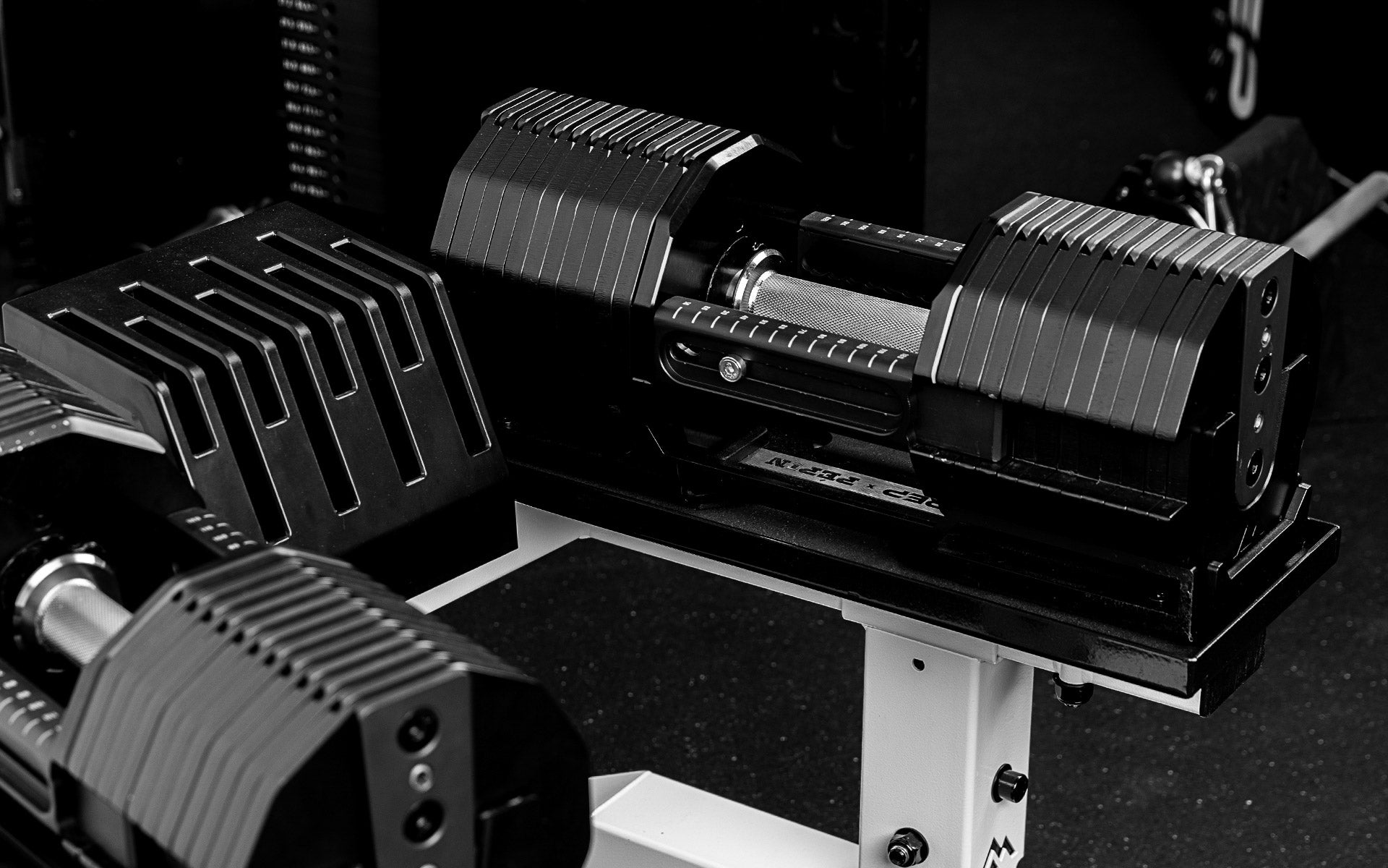 REP x PÉPIN FAST Series Adjustable Dumbbells sitting on the REP Adjustable Dumbbell Stand.