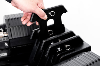 Athlete removing an Add-On Weight from the integrated add-on plate storage on the Adjustable Dumbbell Stand for the REP x PÉPIN FAST Series Adjustable Dumbbell.