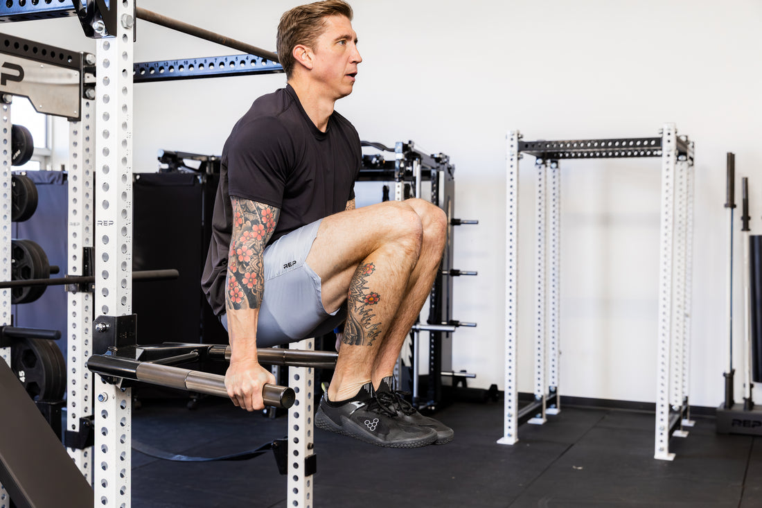 Athlete doing knee raises on the REP Fitness Dip Attachment 2.0