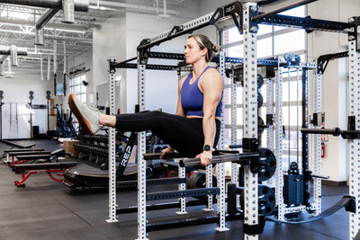 Athlete doing leg lifts on the REP Fitness Dip Attachment 2.0