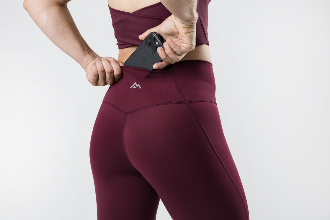 The REP Fitness Women's Eos Legging in Wine back, pocket detail with logo