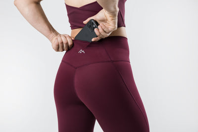 The REP Fitness Women's Eos Legging in Wine back, pocket detail with logo