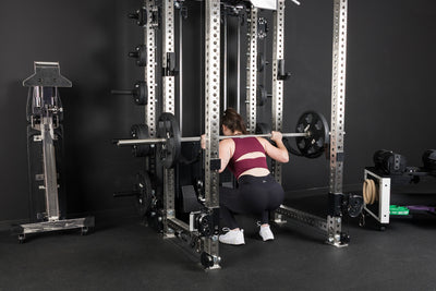 An athlete squatting inside the PR-5000 rack with Equalizer™ Urethane-Coated Plates