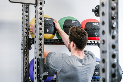 Off-Rack Storage - Showing someone grabbing a medicine ball off of the Ball & Plate Storage Shelf