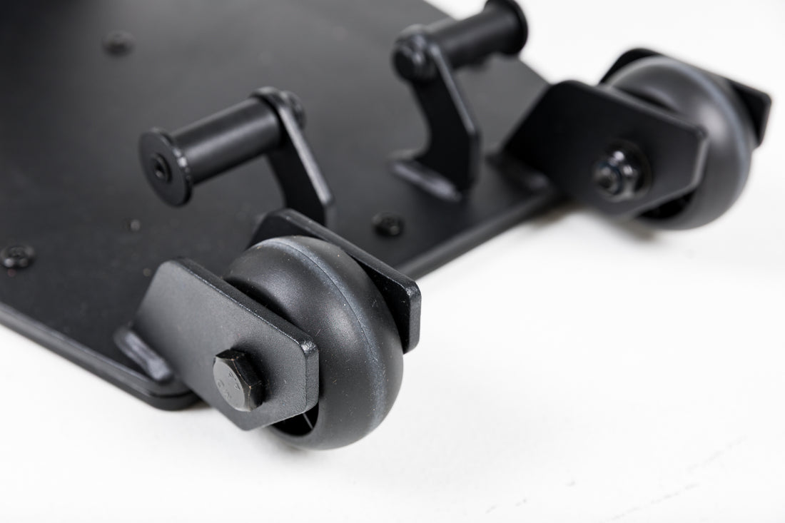 Close-up shot of the wheels on the Leg Extension & Leg Curl Bench Attachment