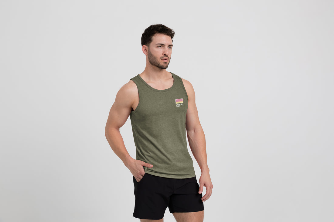 The REP Fitness Men's Rise Tri-Blend Tank in Heather Olive/Red on body