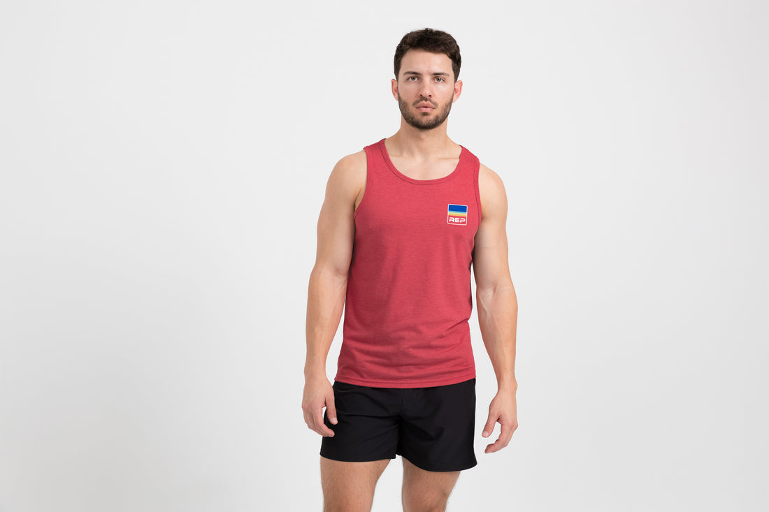 The REP Fitness Men's Rise Tri-Blend Tank in Heather Red/Blue front, on model