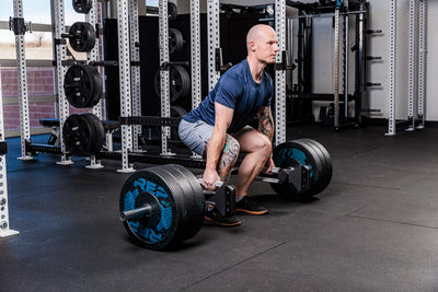 Man performing deadlift with the Fixed Open trap bar in a gym setting