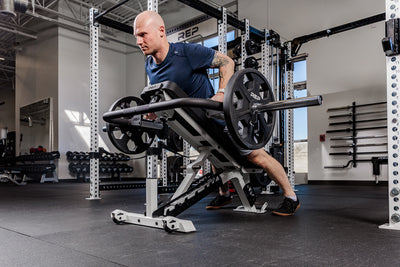 Man performing chest support row with the Fixed Open trap bar in a gym setting