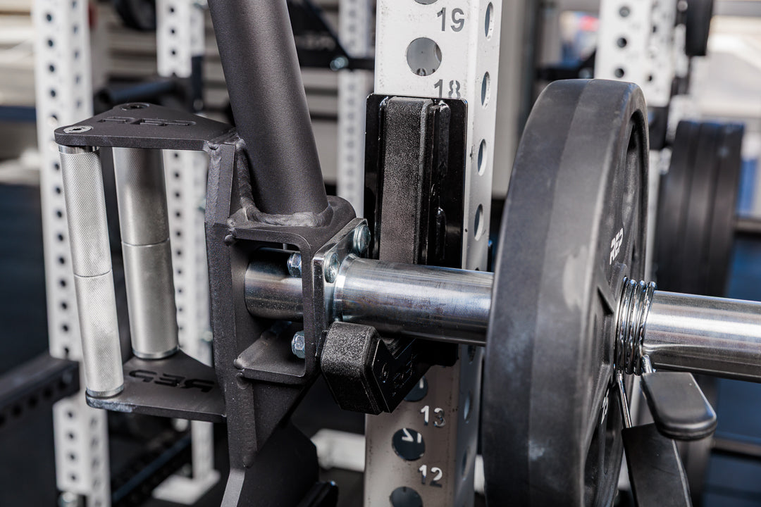 close up of the rackable fixed open trap bar racked onto a j-cup on a squat rack