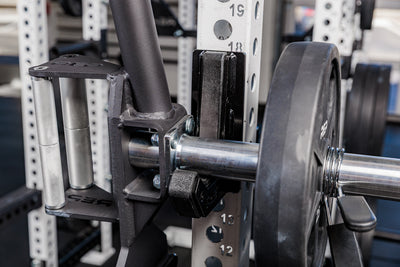 close up of the rackable fixed open trap bar racked onto a j-cup on a squat rack