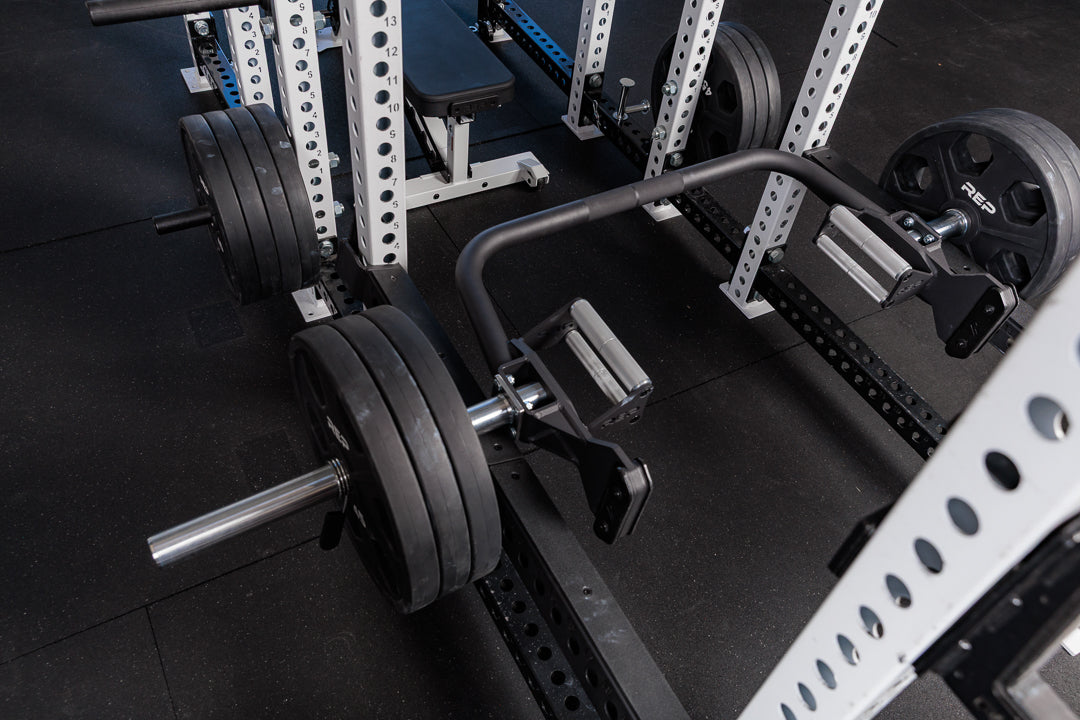 Squat Rack with the rackable fixed open trap bar resting on the safeties