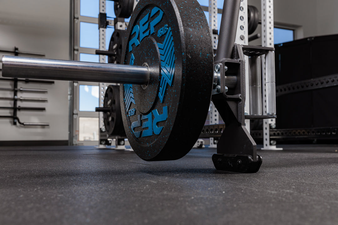 Close-up of the Fixed Open Trap Bar jack and barbell sleeve with weight on it