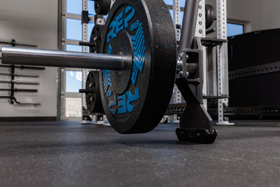 Close-up of the Fixed Open Trap Bar jack and barbell sleeve with weight on it