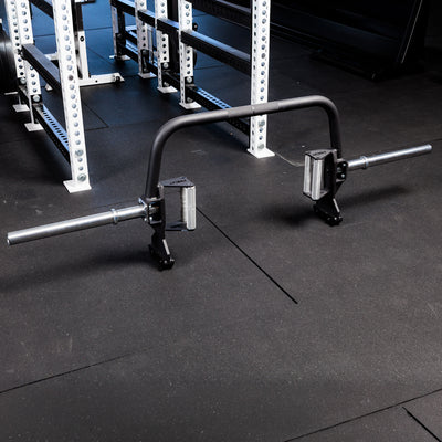 Fixed Open Trap Bar (Rackable)- showing the entire barbell  standing on its built in jacks on the gym floor