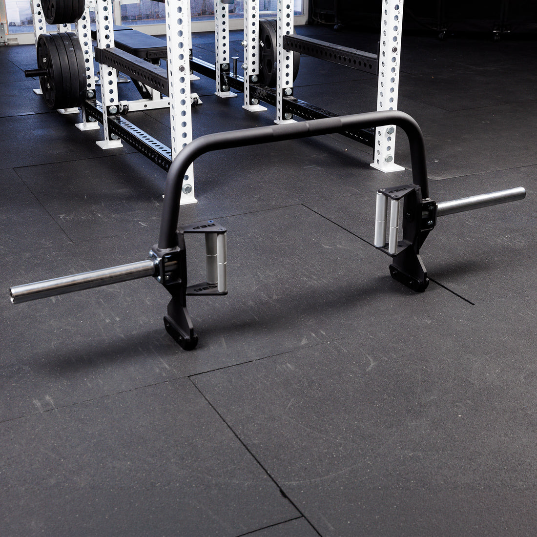 Fixed Open Trap Bar (Compact)- showing the entire barbell  standing on its built in jacks on the gym floor