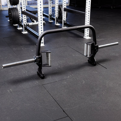 Fixed Open Trap Bar (Compact)- showing the entire barbell  standing on its built in jacks on the gym floor