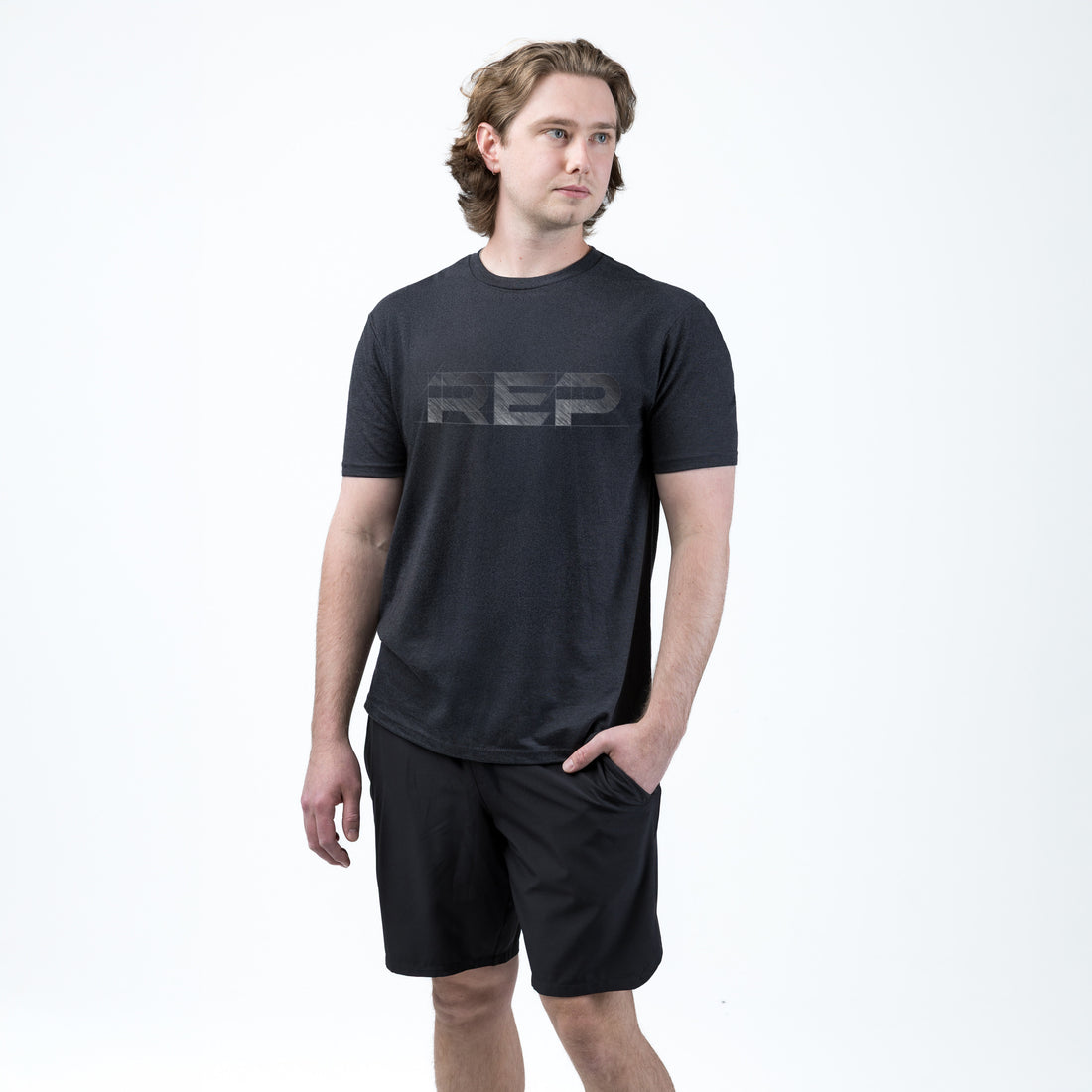The REP Fitness Men's Blueprint Tri-Blend Crew T-shirt in Heather Black/White front, on model