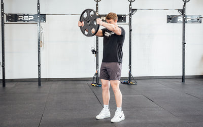 Lifter using a single 45lb USA-Made Equalizer Iron Plate for front shoulder raises.