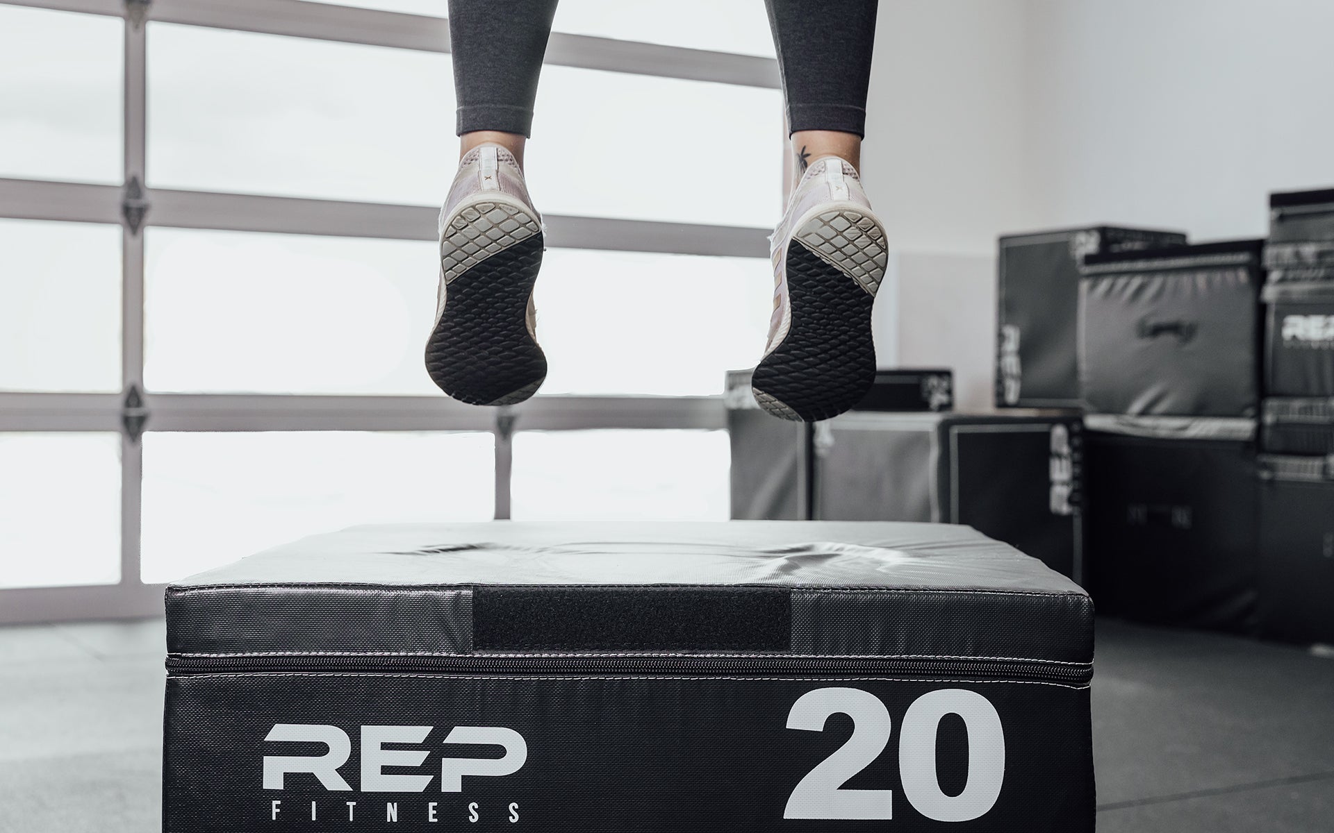 Female athlete performing box jumps on a 20