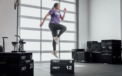 Female athlete performing 16" box jumps on 4" and 12" stacked REP Stackable Soft Plyo Boxes.