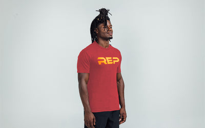 The REP Fitness Men's Daily Driver 2.0 Tri-Blend Crew T-Shirt in Heather Red/Gold on body