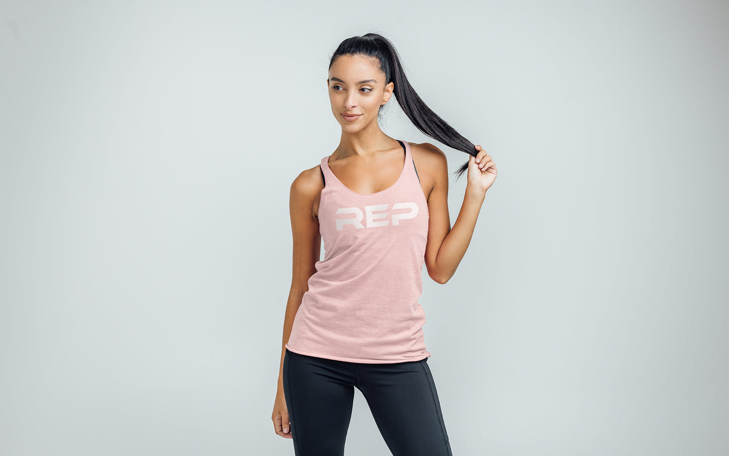 The REP Fitness Women's Daily Driver Tri-Blend Tank in Heather Rose/White on body