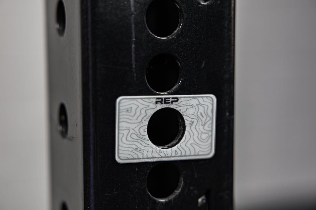 A blank Power Rack Magnetic Position Marker over a bench zone hole on a 4000 series rack upright