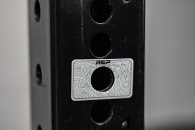 A blank Power Rack Magnetic Position Marker over a bench zone hole on a 4000 series rack upright