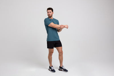 The REP Fitness Men's Delta Shirt in Slate front, stretching