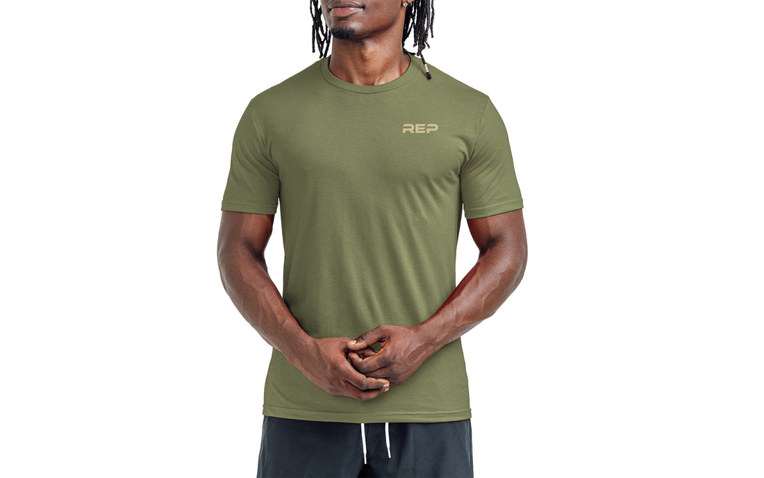 The REP Fitness Men's Engineered Tri-Blend Crew T-Shirt in Heather Olive/Tan front, on model