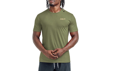 The REP Fitness Men's Engineered Tri-Blend Crew T-Shirt in Heather Olive/Tan front, on model