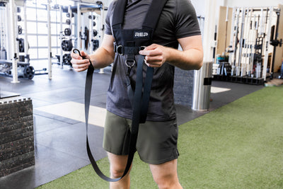 Person holding the Heavy-Duty Webbing Pull Strap with Dual Carabiners