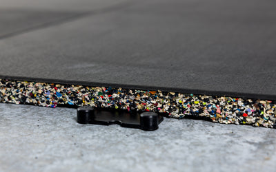 Close-up of one Interlocking Floor Tile connected to one side of one four-way dowel connecting piece 