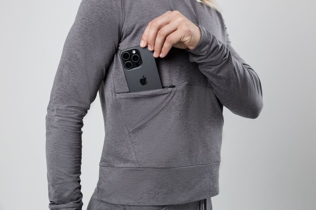 The REP Fitness Women's Vellus Hoodie in Heather Cool Gray front, phone in pocket