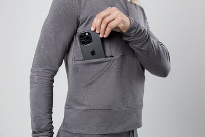 The REP Fitness Women's Vellus Hoodie in Heather Cool Gray front, phone in pocket