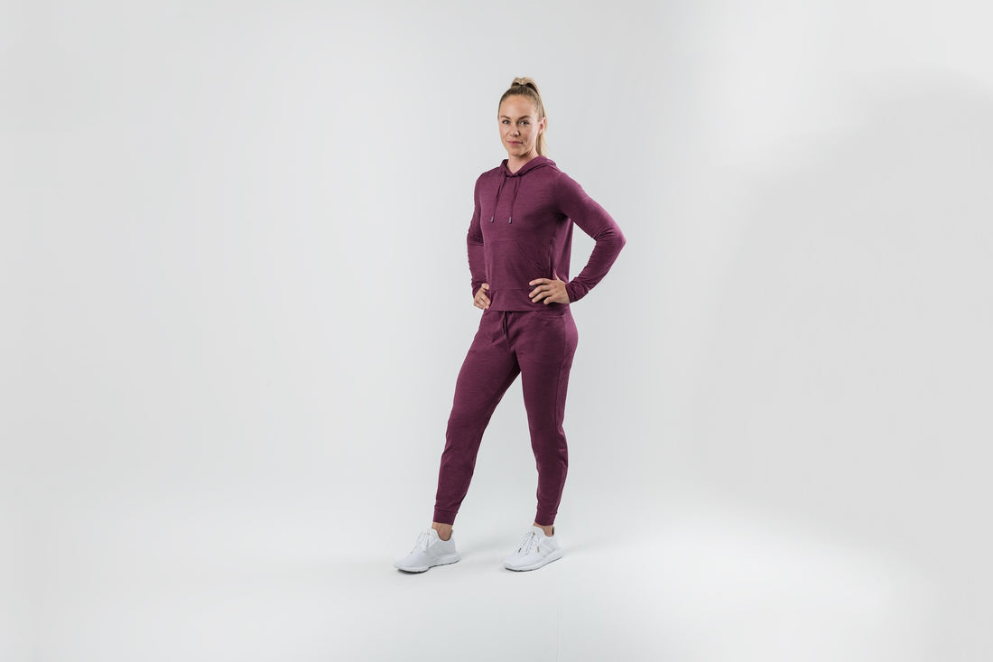 The REP Fitness Women's Vellus Hoodie in Heather Wine side, hand on hip