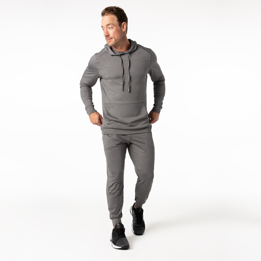 The REP Fitness Men's Apollo Hoodie in Heather Cool Gray front, walking