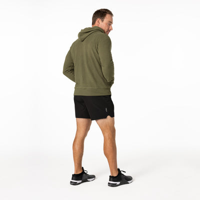 The REP Fitness Men's Stratix Hoodie in Olive looking over shoulder