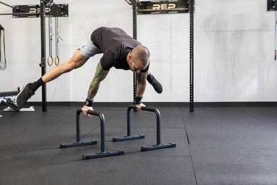 Athlete performing calisthenics on the REP Fitness Parallette Bars