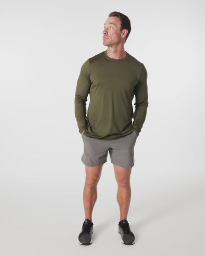 Athlete wearing the REP Fitness Men's Delta Long Sleeve Crew T-Shirt in Heather Black, Heather Cool Gray, Heather Olive