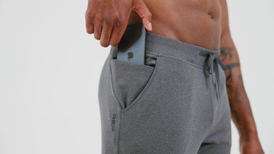 Athlete wearing the REP Fitness Men's Attis Joggers in Heather Olive, Heather Black, Heather Cool Gray design detail