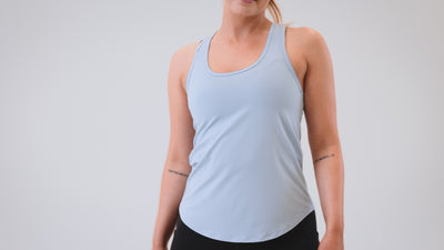 Athlete wearing the REP Fitness Women's Clio Tank Top in Olive, Black, Periwinkle