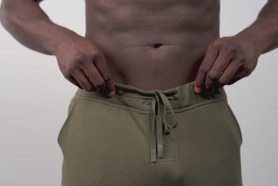 Athlete wearing the REP Fitness Men's Attis Joggers in Heather Olive, Heather Black, Heather Cool Gray close-up
