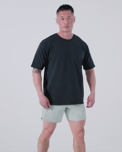 Athlete wearing the REP Fitness Men's Magnis Heavyweight T-Shirt in Aqua Gray, Black, Navy