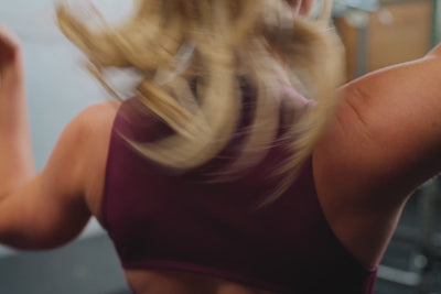 Video of an athlete performing deadlifts while wearing the REP Rhea tank in Wine