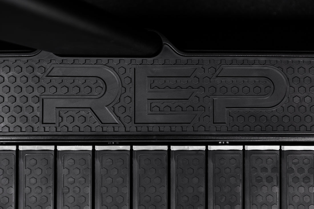 The REP Fitness branding on the sides of the Strive Curved Treadmill deck
