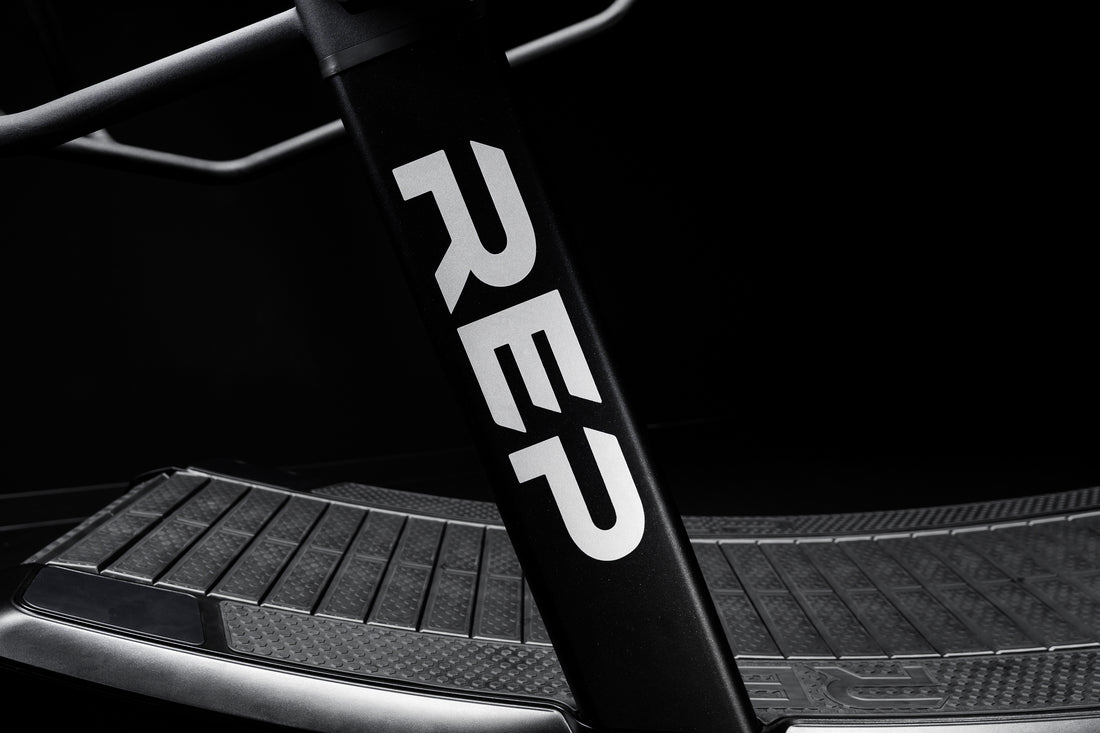 The REP Fitness branding on the side of the Strive Curved Treadmill
